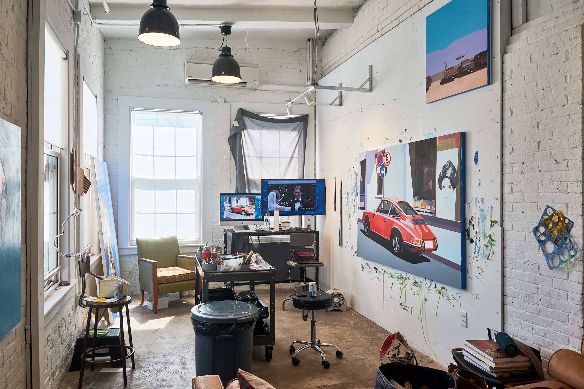 Art studio with paintings work desk set up